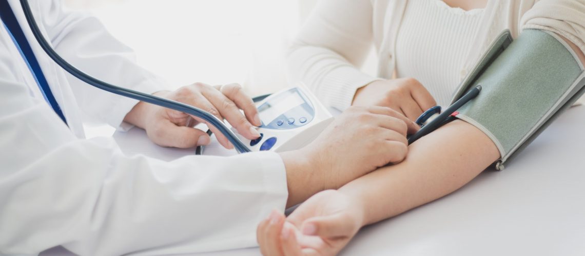 The doctor measures blood pressure to the patient